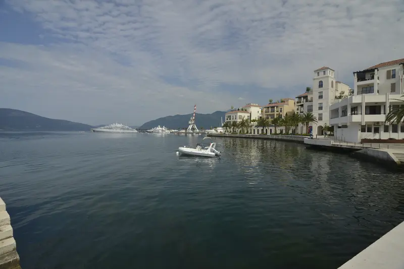 The Porto Montenegro marina at Tivat, superyachts and a palm-lined waterfront below the Vrmac ridge