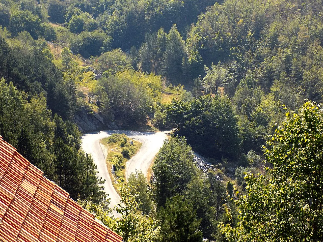 A serpentine switchback on the R-1 road descending Lovćen toward Kotor and the bay
