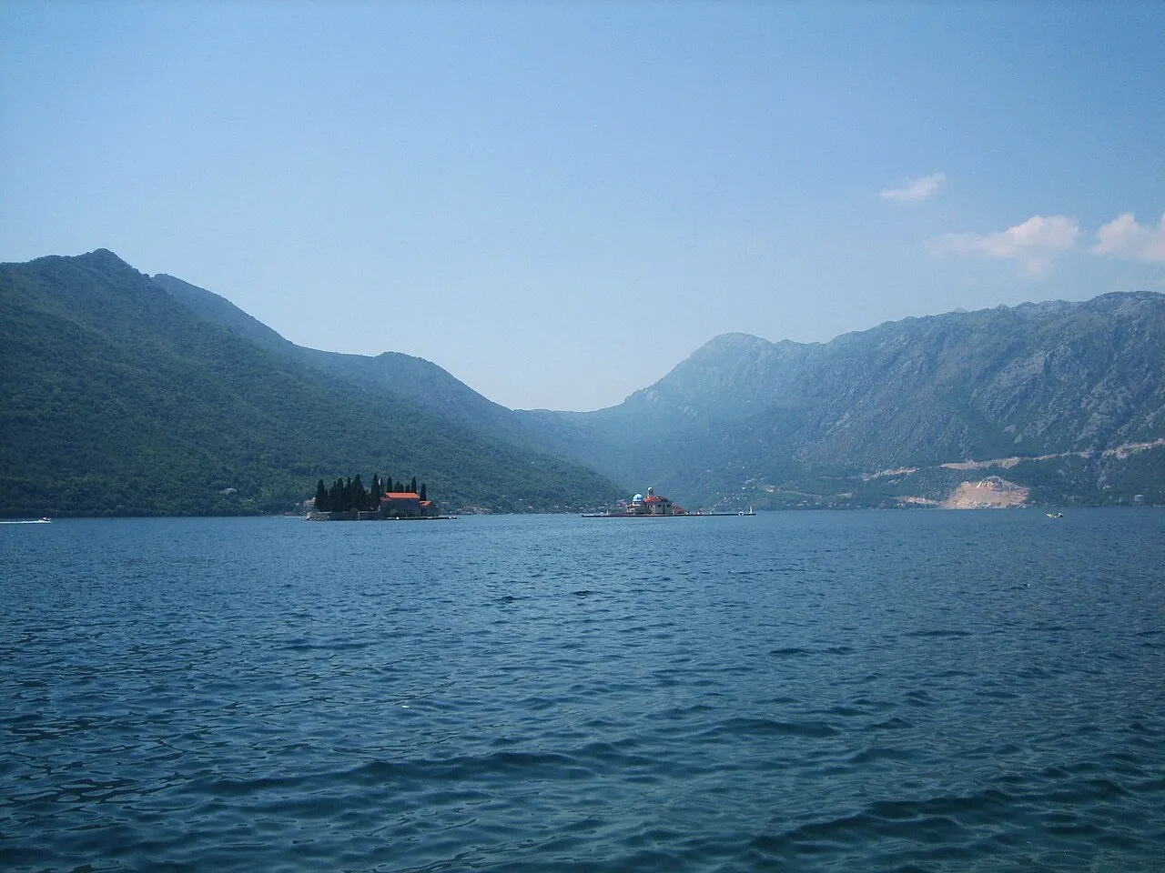 The Perast waterfront and the offshore island church of Our Lady of the Rocks with Sveti Đorđe on the Bay of Kotor