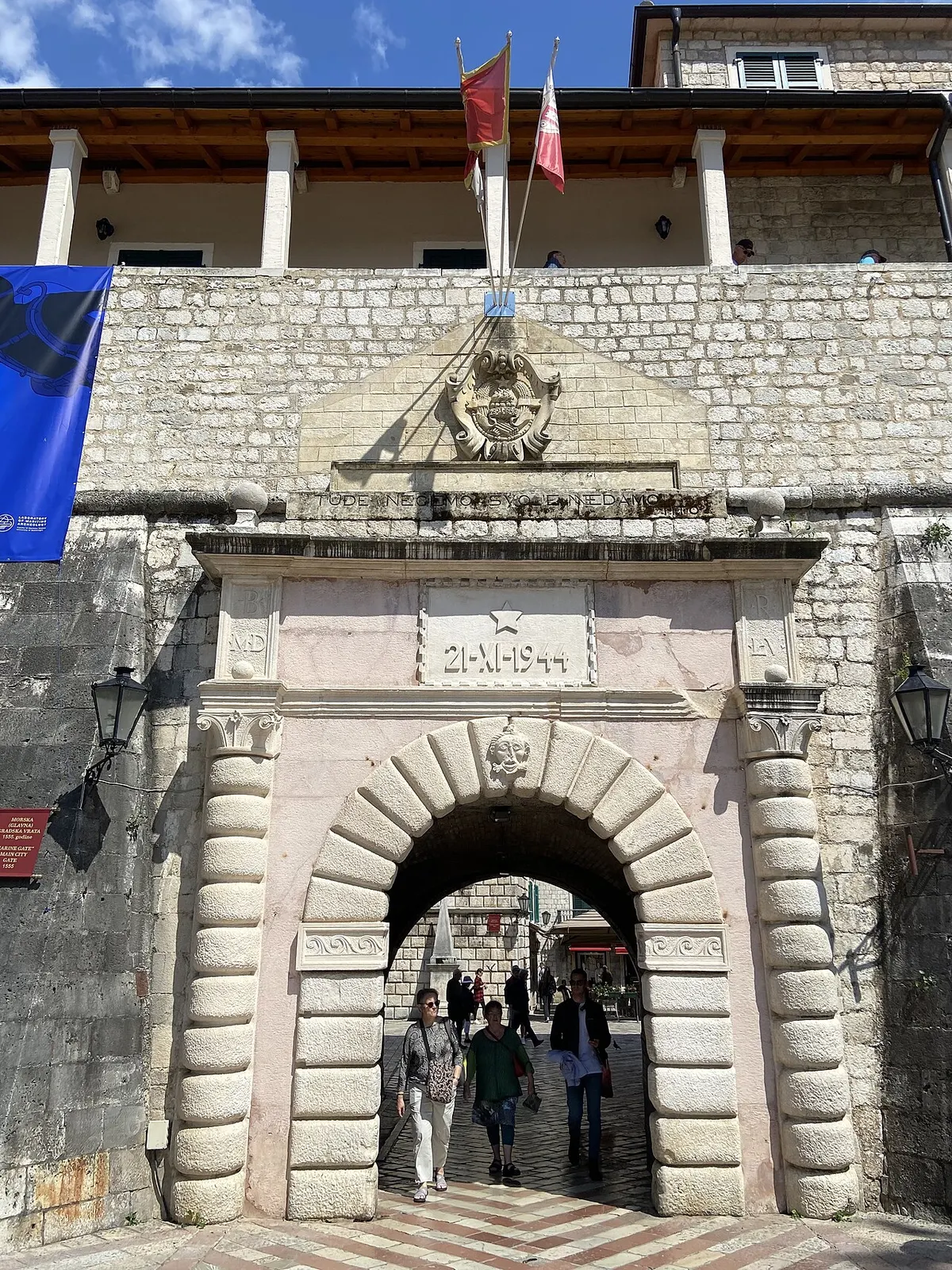 The Sea Gate, the main stone entrance into Kotor's walled Old Town, flags flying above