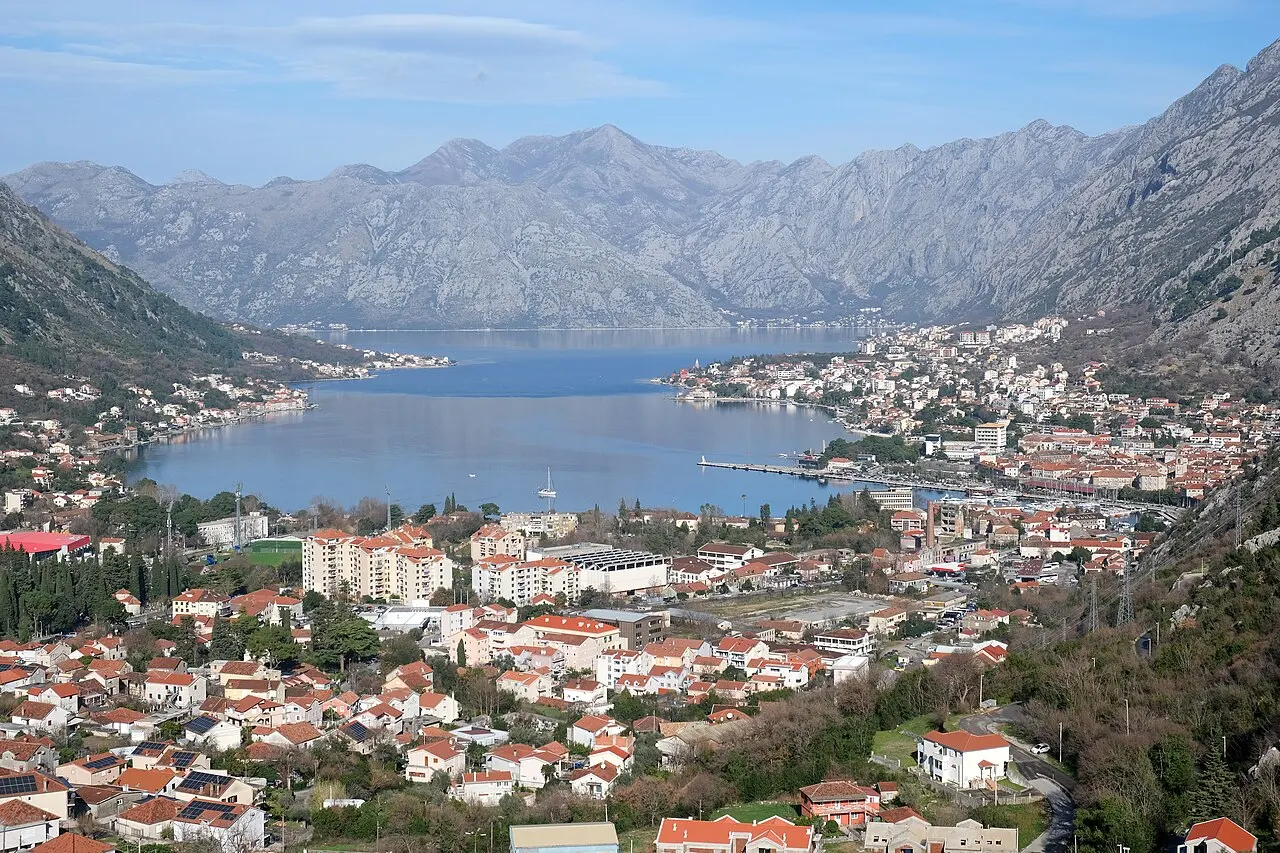 The Bay of Kotor in soft clear light, mountains rising above calm water