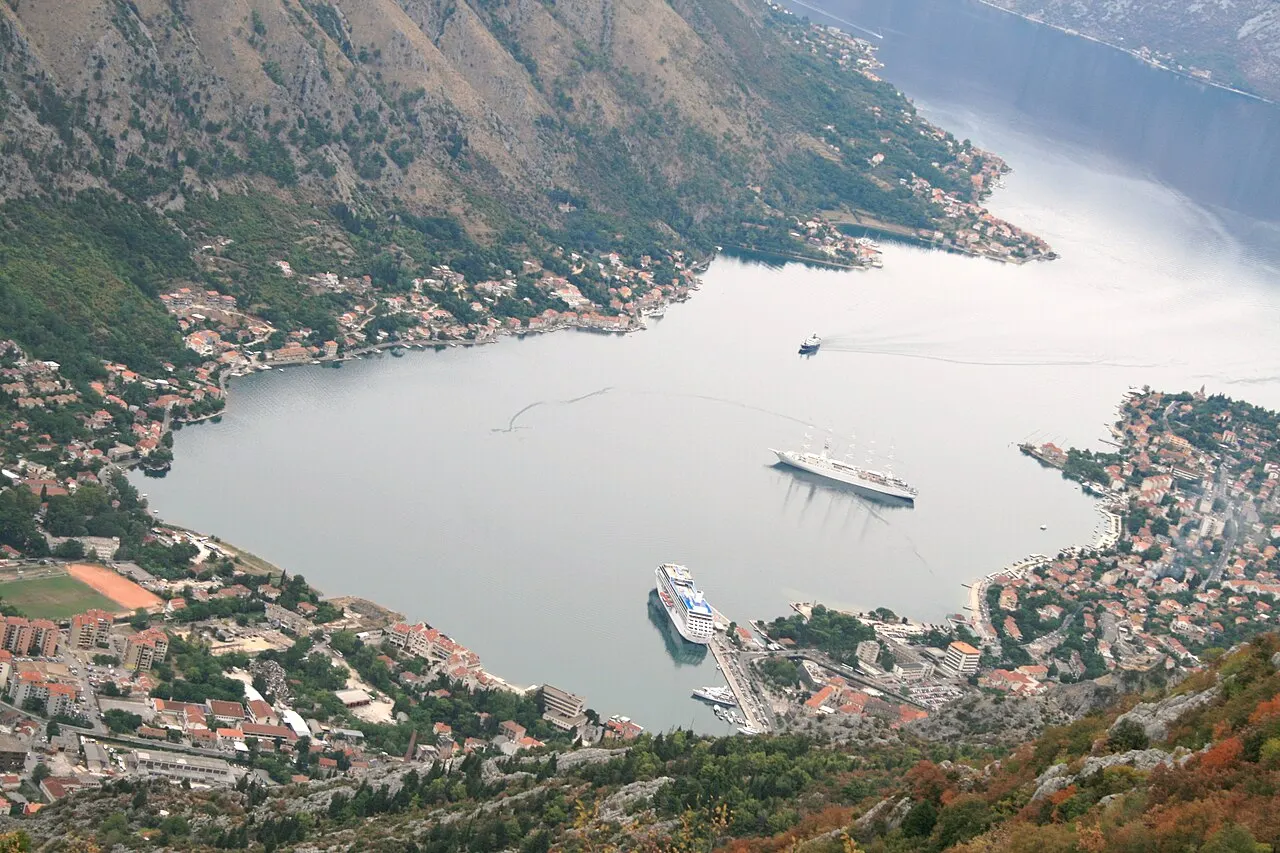 Aerial view of the head of the Bay of Kotor with cruise ships at the berth and the Old Town below the mountains