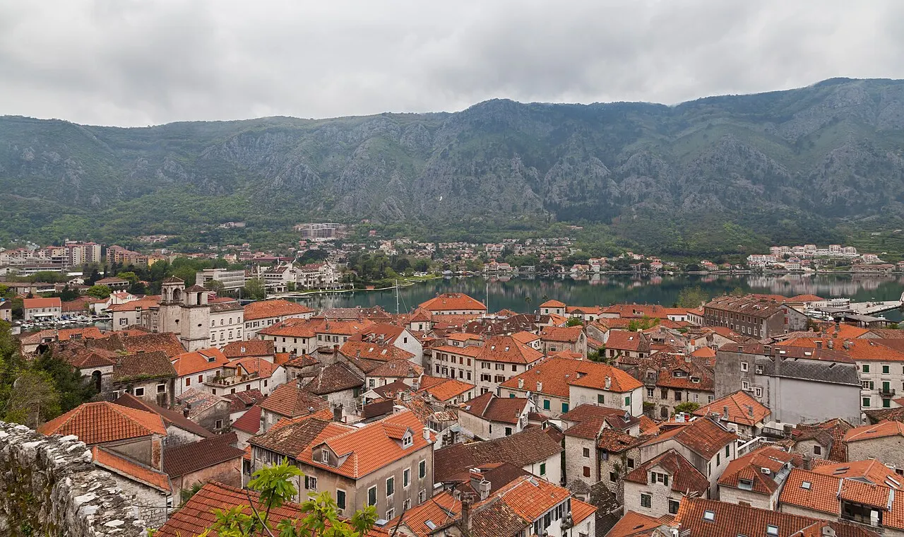 Kotor's Old Town red-tiled rooftops and the Bay of Kotor seen from the city walls above