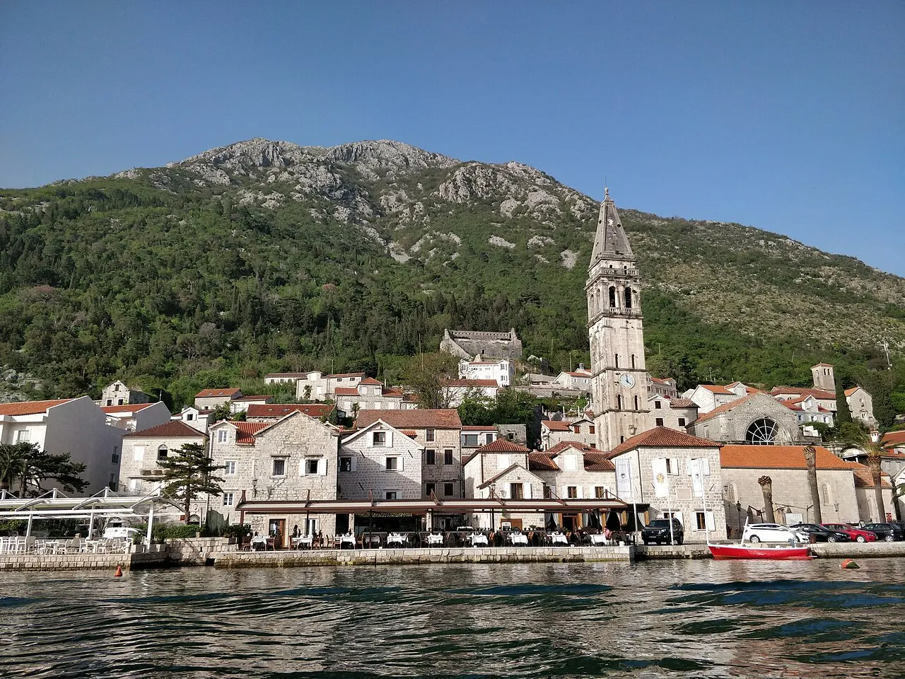 Perast and its bell tower on the Bay of Kotor seen from a boat on the water
