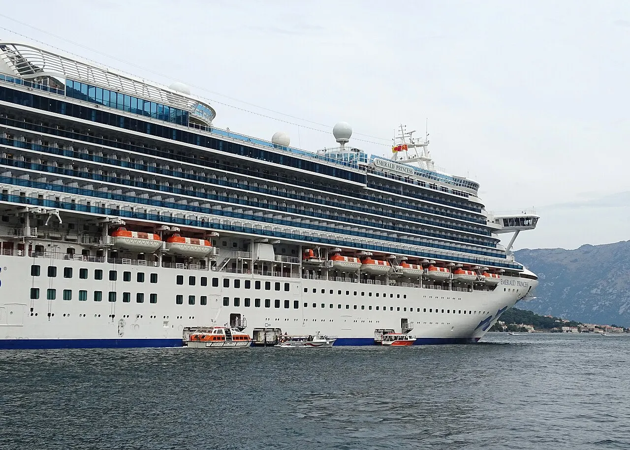 The cruise ship Emerald Princess berthed on the quay beside Kotor's Old Town walls
