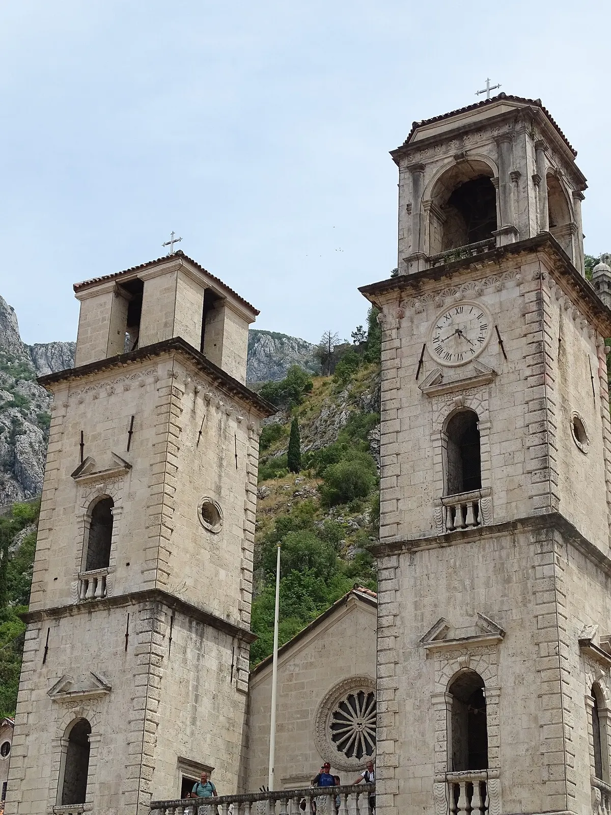 The twin Romanesque towers and facade of St Tryphon Cathedral above its square in Kotor