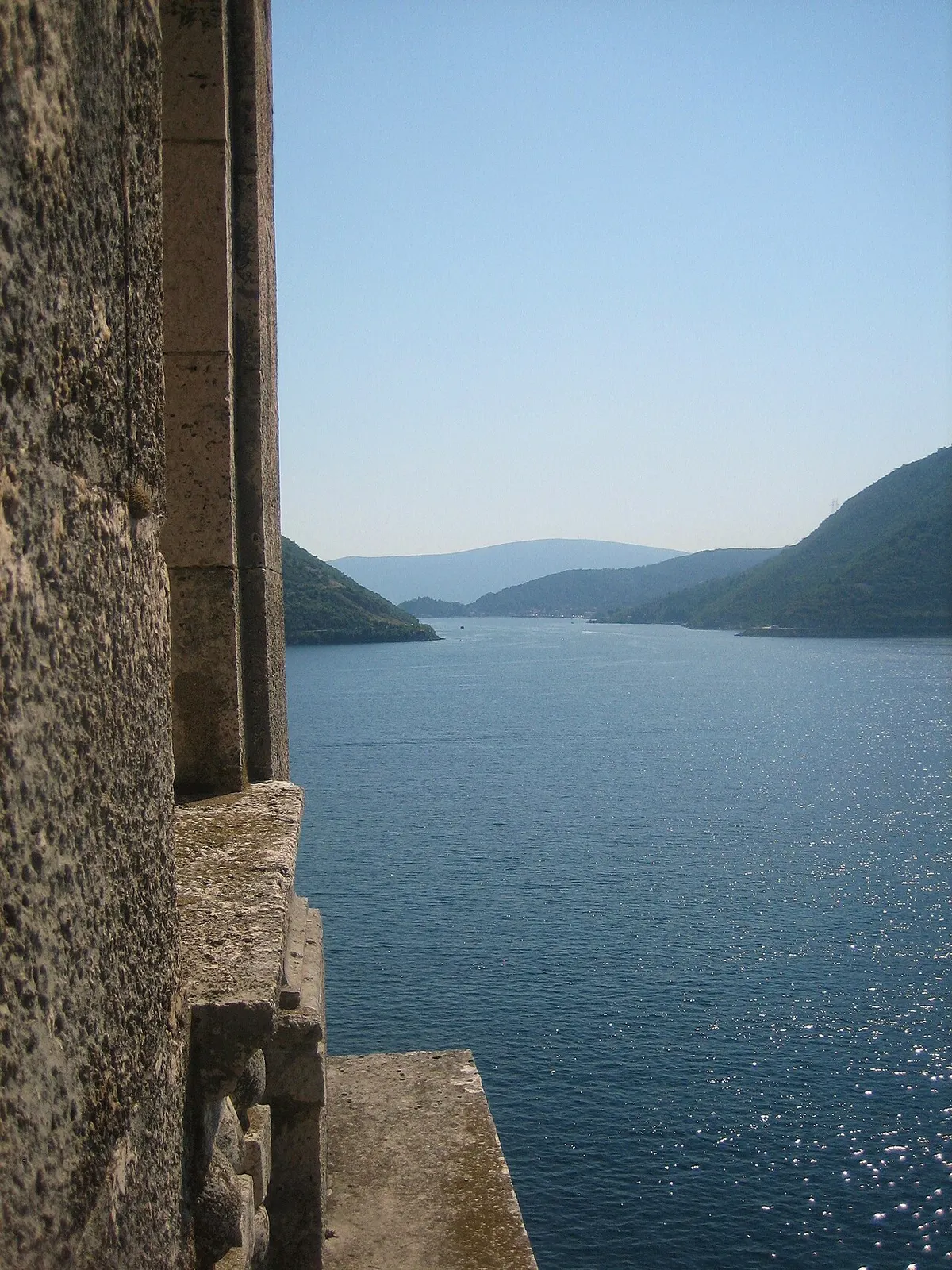 Perast, its bell tower and the bay islands on the glassy inner Bay of Kotor
