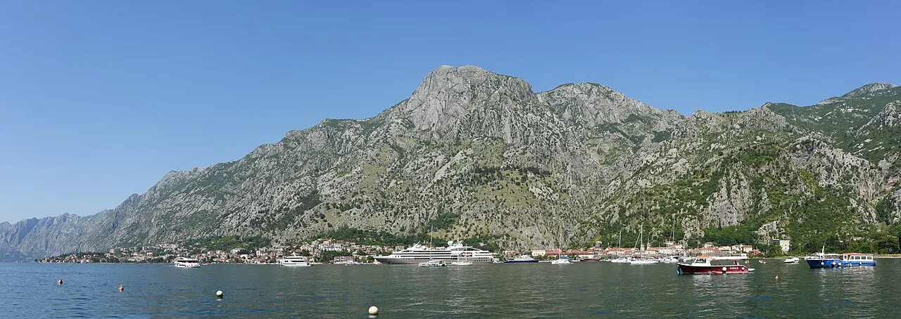 The shore of the Bay of Kotor with the town of Kotor and its walls beneath the cliffs