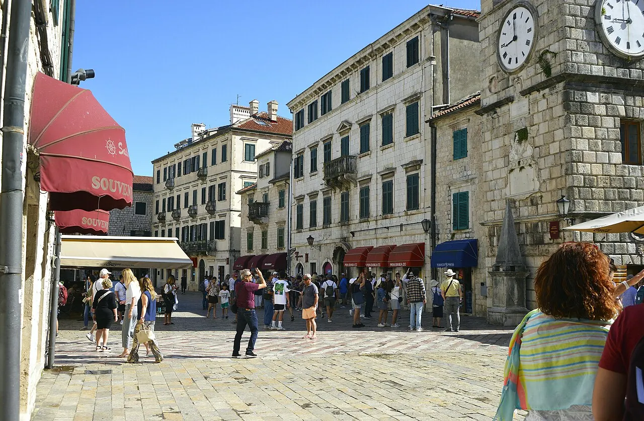 Crowds of visitors filling Kotor's Arms Square below the Clock Tower on a busy day