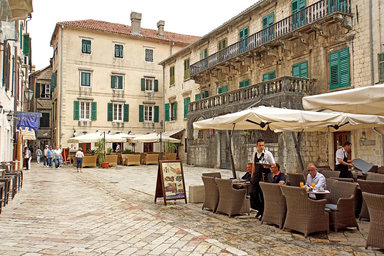 Flour Square in Kotor's walled Old Town, stone palace facades around an open paved square