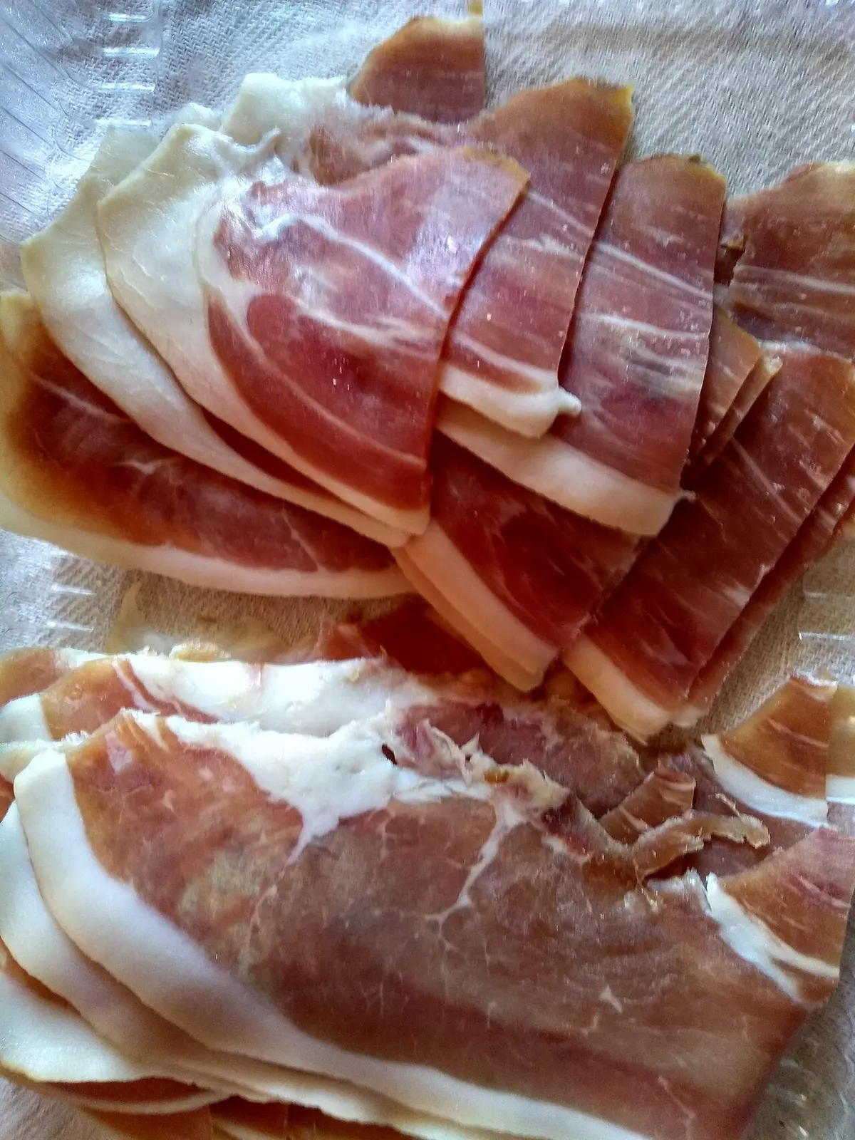 Sliced Njeguši prosciutto, a Montenegrin cured-ham speciality, on a serving board