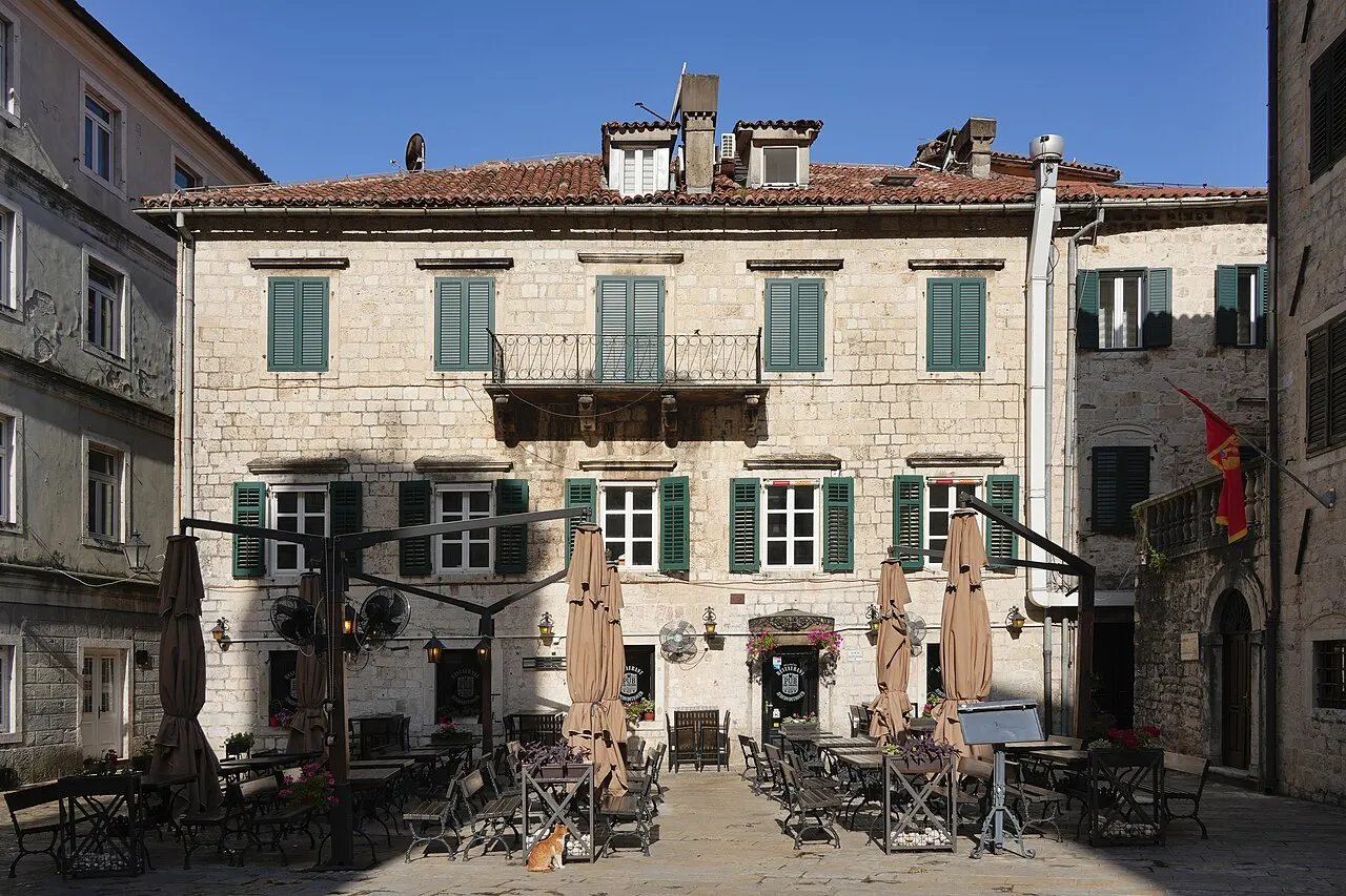 A stone townhouse and cafe terrace on Kotor's Arms Square in the Old Town