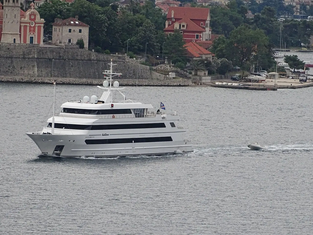 A private luxury yacht cruising the Bay of Kotor below the old shoreline