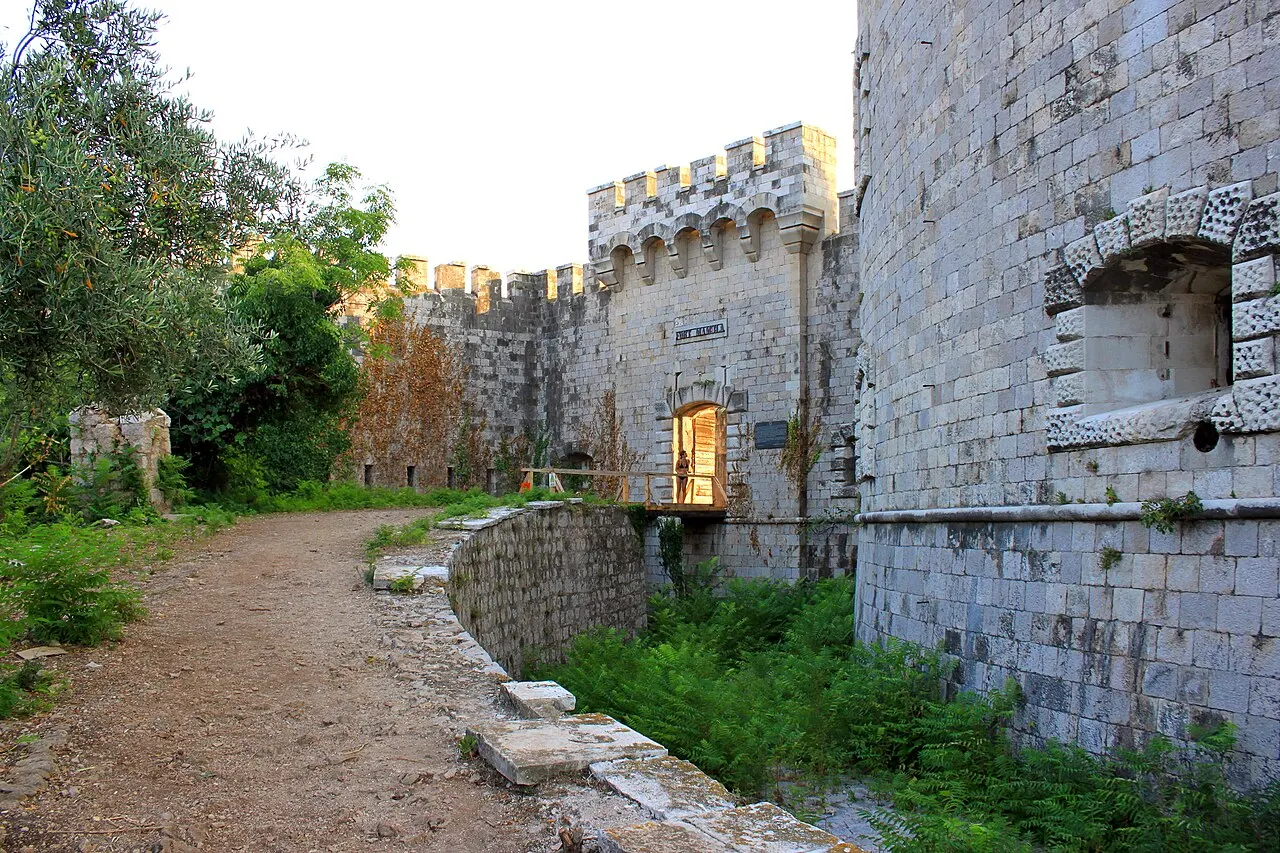 Crenellated stone walls and gateway of Fort Mamula in the Bay of Kotor
