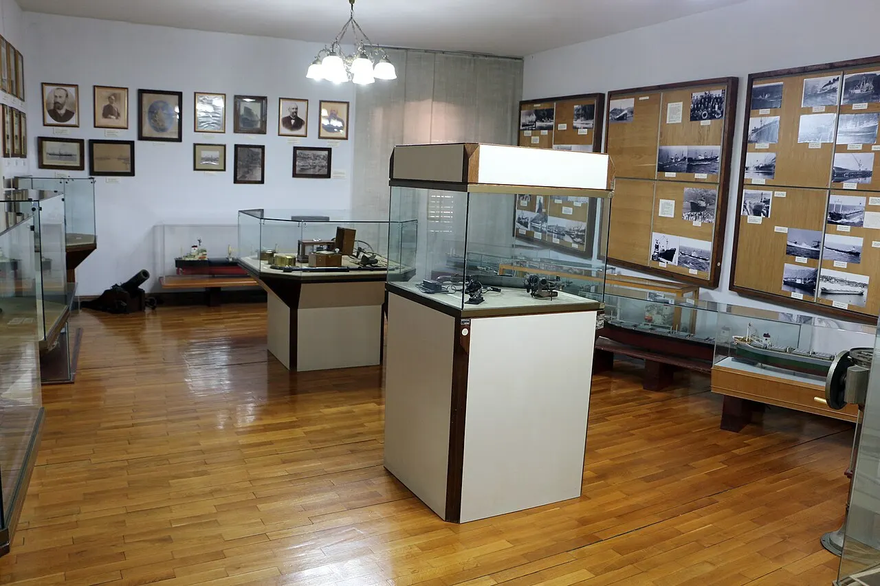 Glass display cases of nautical instruments, portraits and photos in the museum