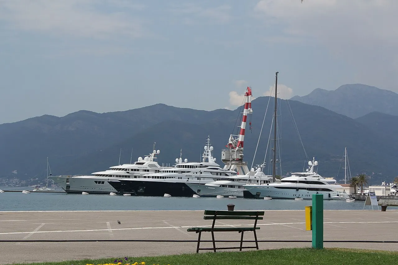 Superyachts moored at Porto Montenegro marina in Tivat below the bay's mountains