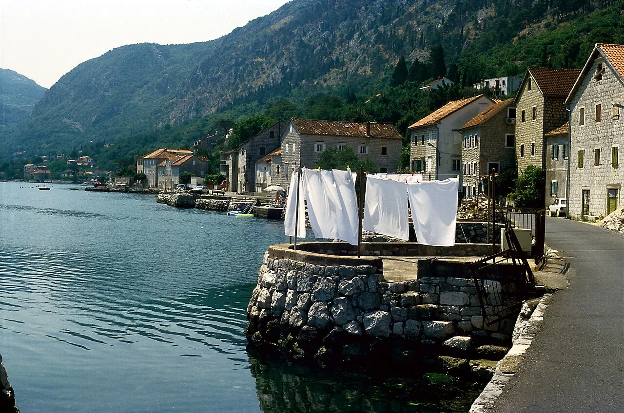 The waterfront single street of Muo, old stone houses and bathing steps along the bay shore