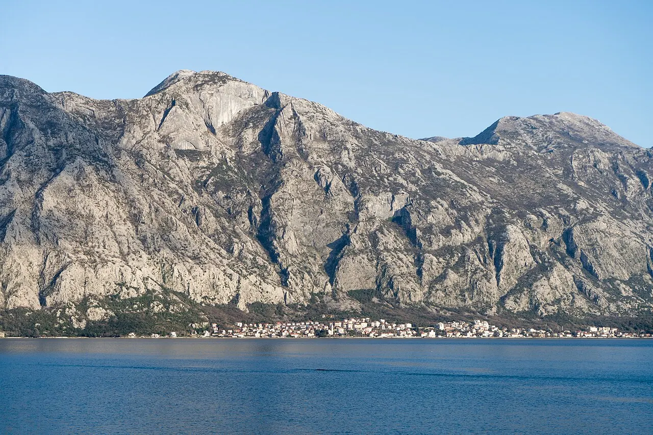 The northern shore of the Bay of Kotor seen from the road toward Perast, a village along calm water below steep mountains