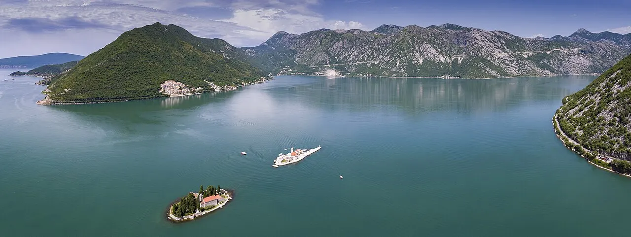 Aerial of the two islands off Perast: domed Our Lady of the Rocks and cypress-shaded St George