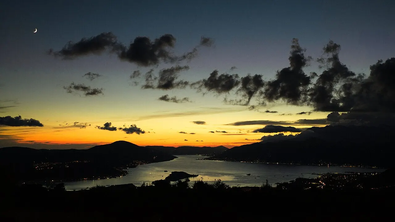 Kotor's walled Old Town across the calm bay just after sunset