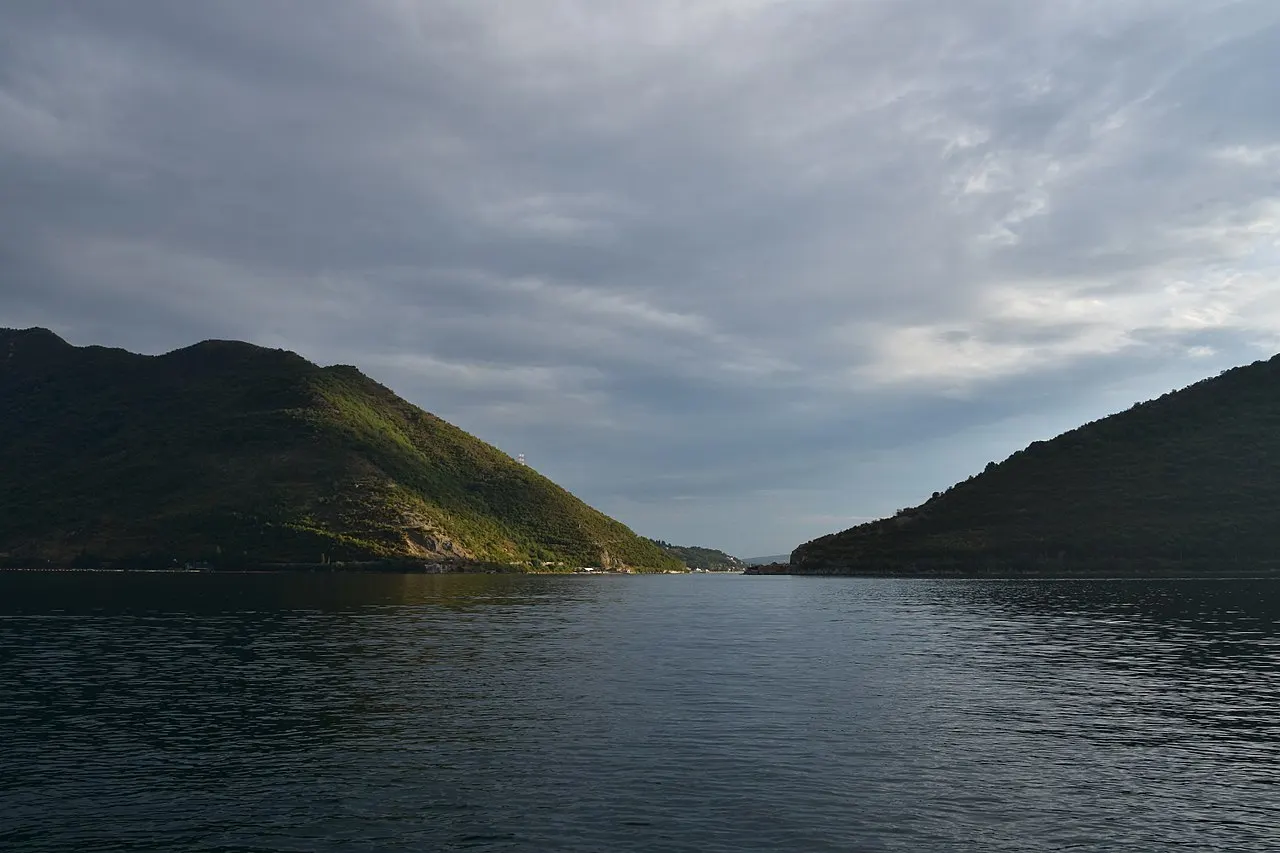 The Bay of Kotor near Perast in warm light, mountains glowing above the water