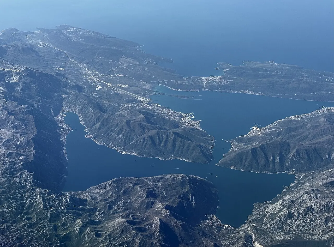 Aerial view of the whole Bay of Kotor, its winding basins from the Adriatic inland past Tivat to Kotor