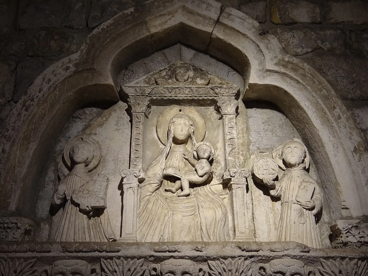 The carved Gothic relief of the Virgin and Child set inside the Sea Gate arch in Kotor's Old Town