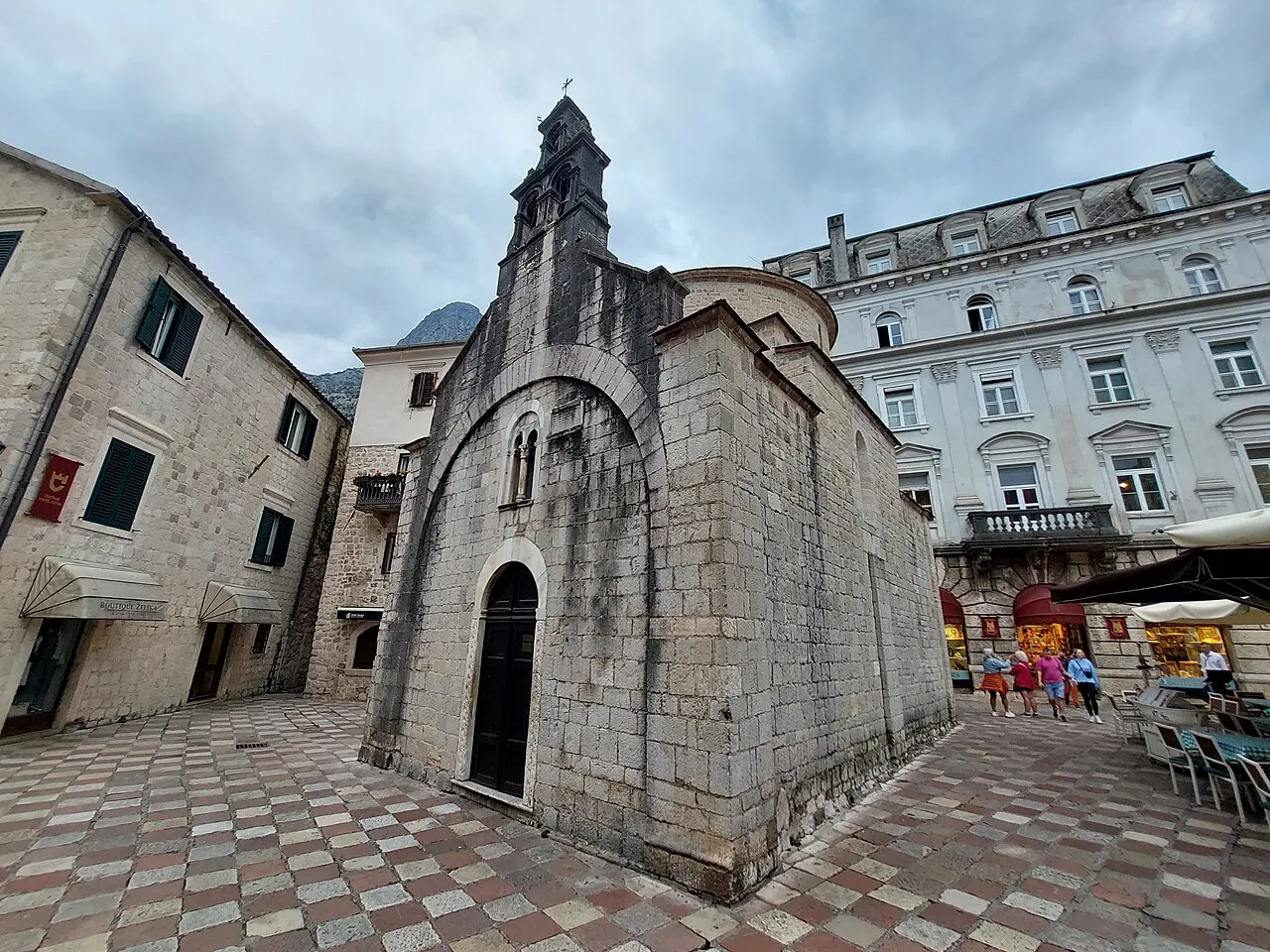 The stone entrance and bell-cote of St Luke's Church in Kotor's Old Town on a quiet morning