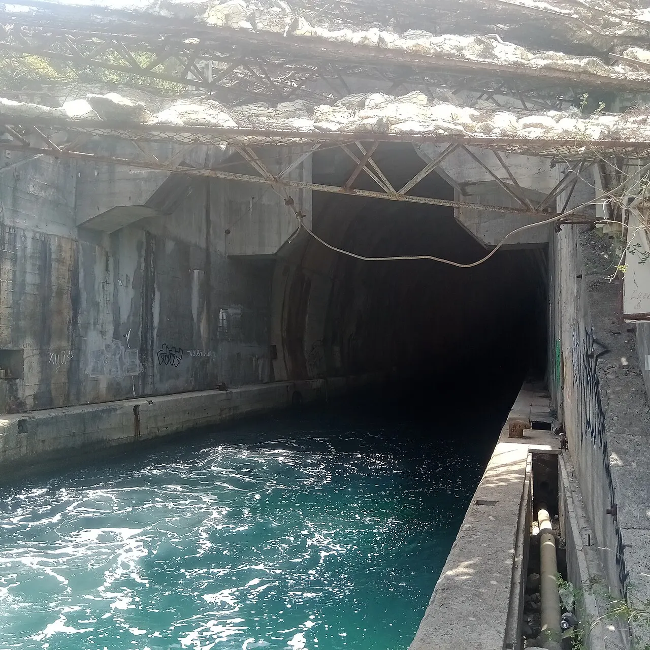 A former Cold War submarine tunnel cut into the rock at the water's edge in Montenegro