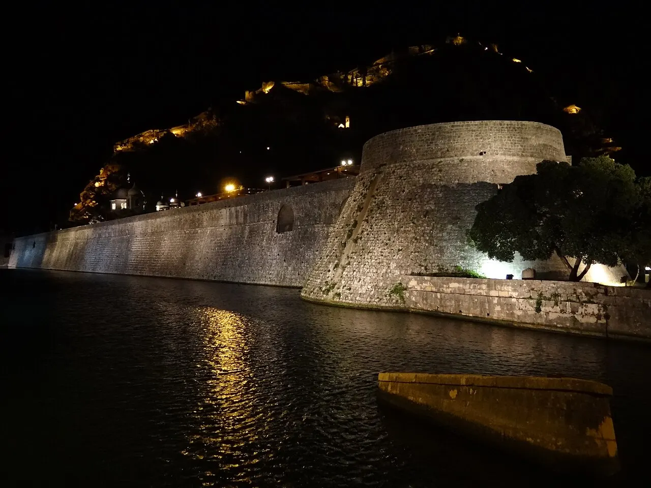 Kotor's Old Town walls and buildings floodlit at night